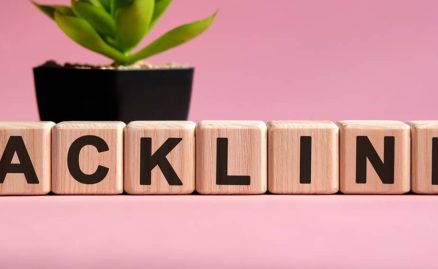 The words 'backlinks' spell out with cubes in front of a pink backdrop.